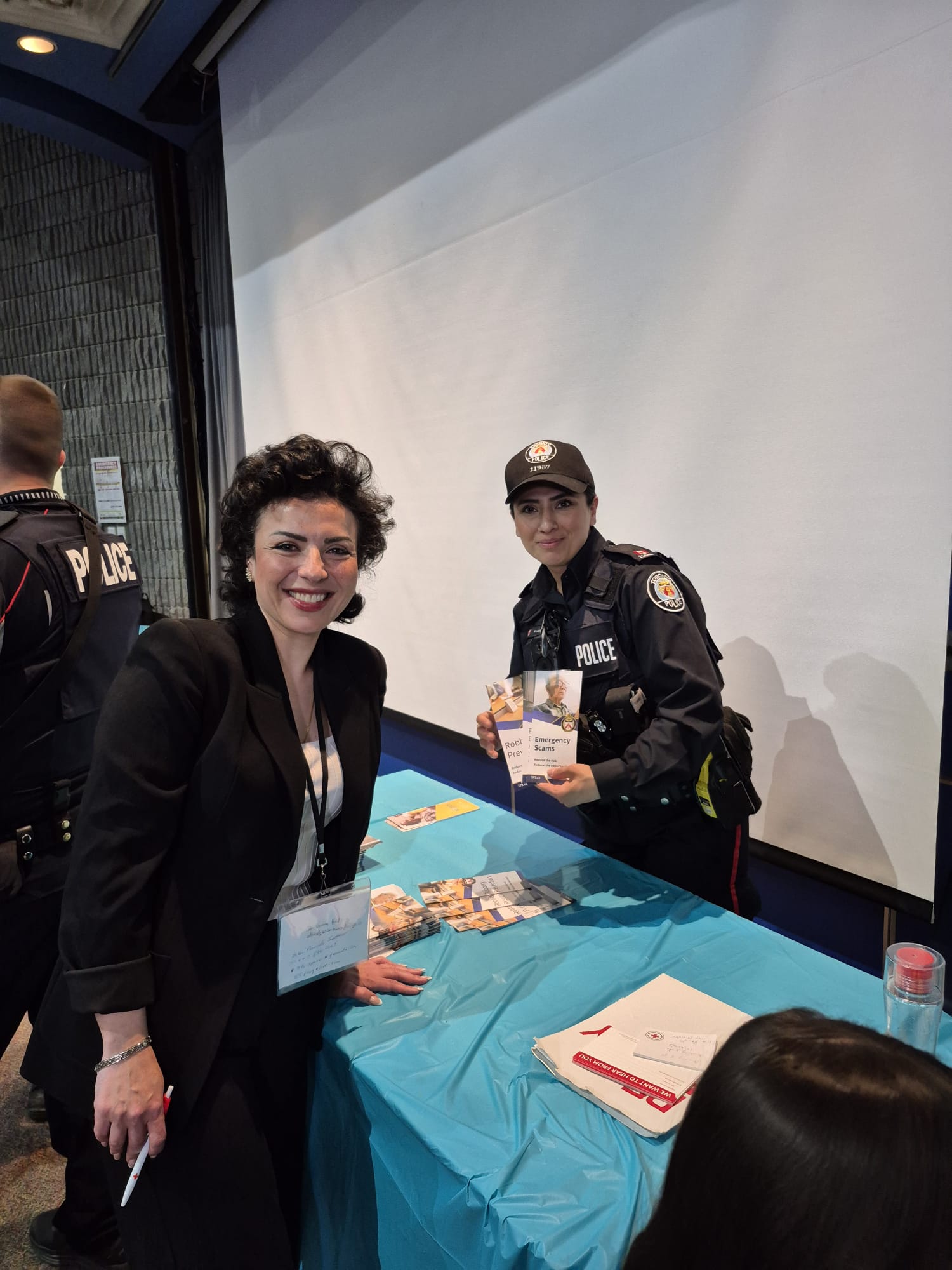 Bahareh Barahmand with a Toronto Police officer at a community safety information table